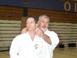 Kyoshi McCarthy explaining pressure points on Sensei Rick Ouellette (Ottawa co-host).