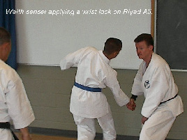 Waith sensei applying a wrist lock on Riyad Ali.