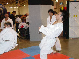 Ehsan Debaji footsweeps Mohamed Fizali during sparring demonstration for Queen Elizabeth II's walkabout tour.