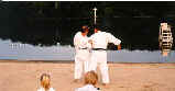 Moledzki Sensei explaining arm bar application from Heian Nidan on Sensei Desjardins.